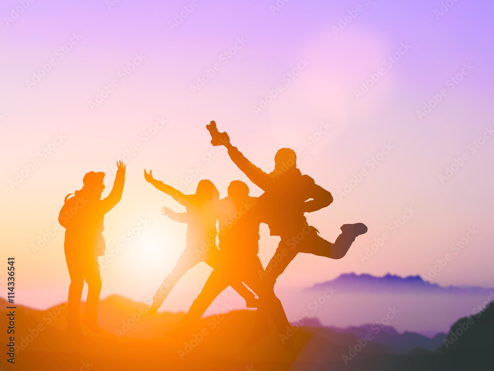 Fototapeta premium Silhouette friends jumping with joy and happiness over blurred,