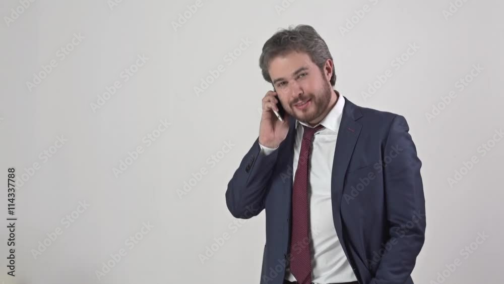 Businessman in suit with tie talking on the phone Businessman in suit with tie talking on the phone