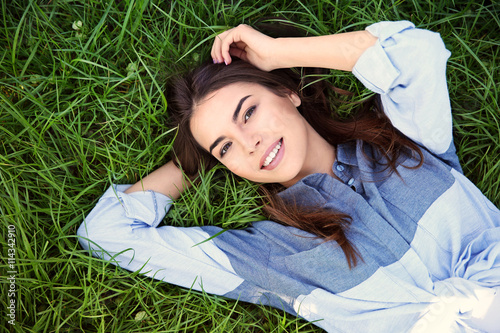Beautiful girl lying on gre...