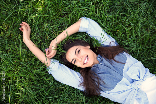 Beautiful girl lying on gre...