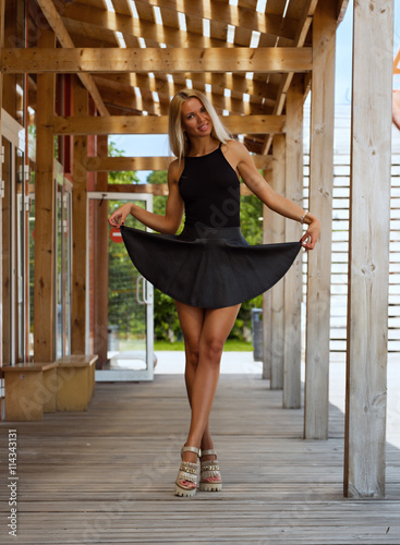 Bild auf Leinwand Beautiful girl in a short black skirt