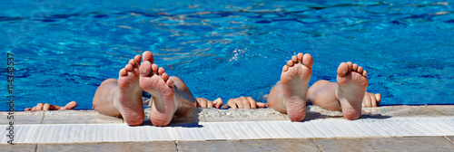 Children's feet in a spray of water in the pool