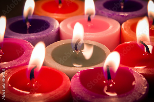 close up multi color flame candle as a background