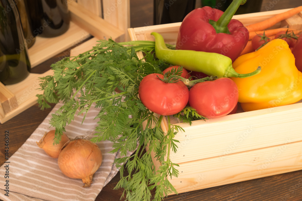 Fresh market vegetables in the wood box with objects in the background Fresh market vegetables in the wood box with objects in the background