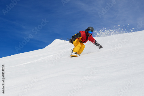 snowboarder very quickly goes down slope freerider