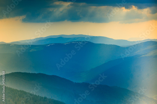 Landscape of misty mountain hills at distance.