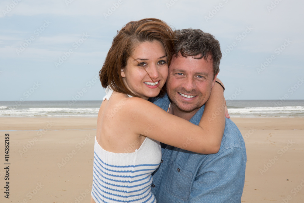 Cheerful couple laughing together at the beach Cheerful couple laughing together at the beach
