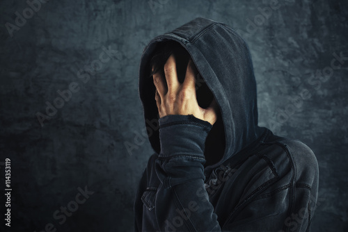 Hooded person fighting addiction crisis photo
