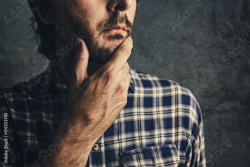 Billede på lærred Casual man in plaid shirt thinking and contemplating