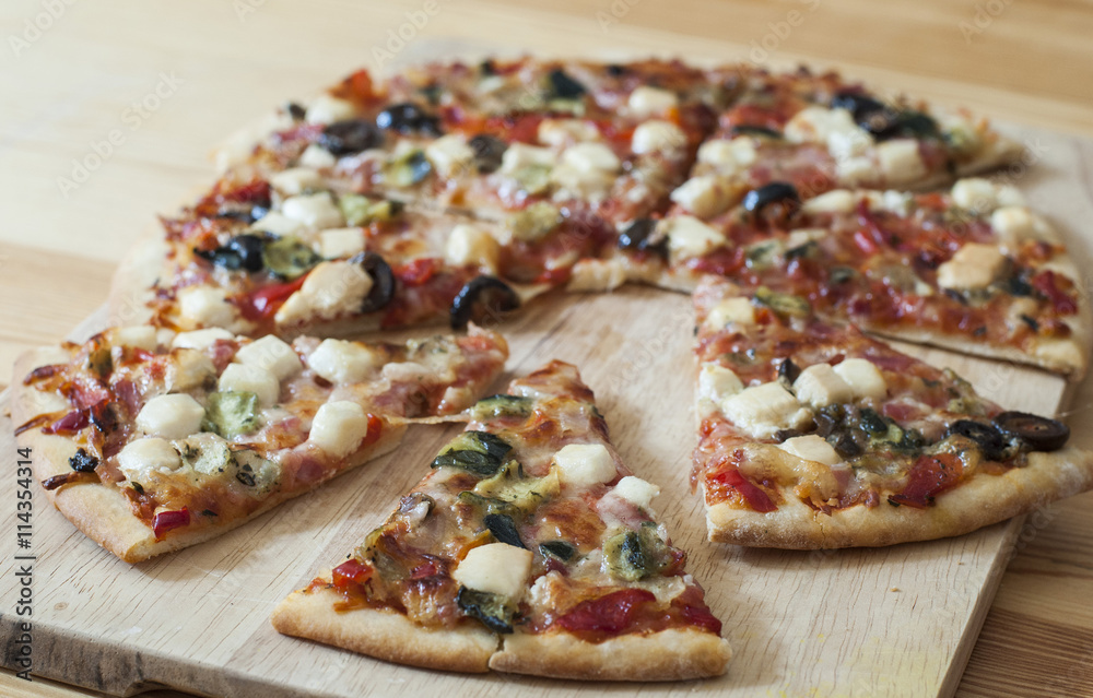 Delicious homemade pizza with tomato, cheese, pepperoni, olives and mushrooms. Delicious homemade pizza with tomato, cheese, pepperoni, olives and mushrooms.