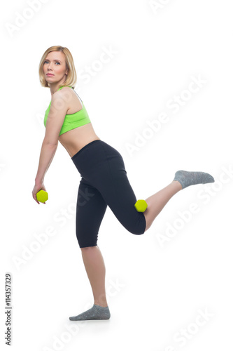 Beautiful woman doing sport exercise with dumbbells