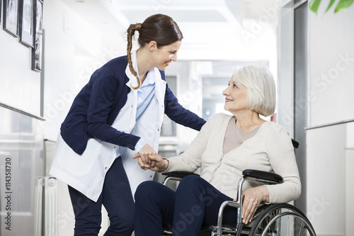 Photography Physiotherapist Consoling Senior Woman Sitting In Wheelchair