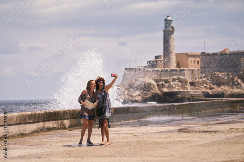 Tourist Girls Taking Selfie With Mobile Phone In Havana Cuba © Diego Cervo