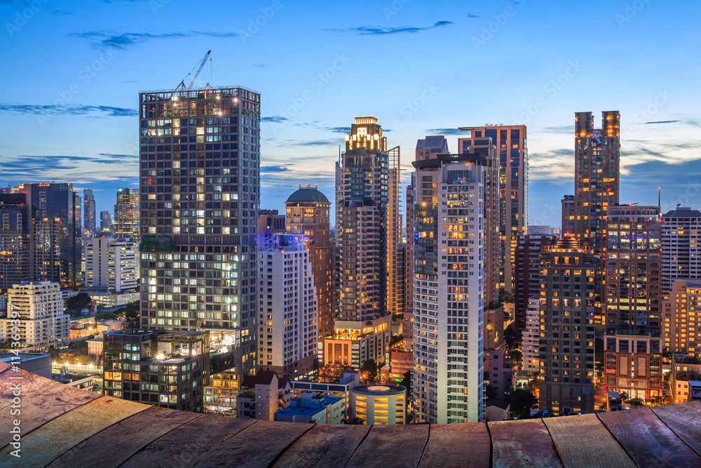 night light of Bangkok wooden floor. Panoramic and perspective view background of glass high rise building skyscraper commercial of future. Business concept of success industry tech architecture