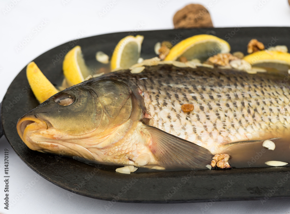 carp in jelly with lemon, walnuts and almonds