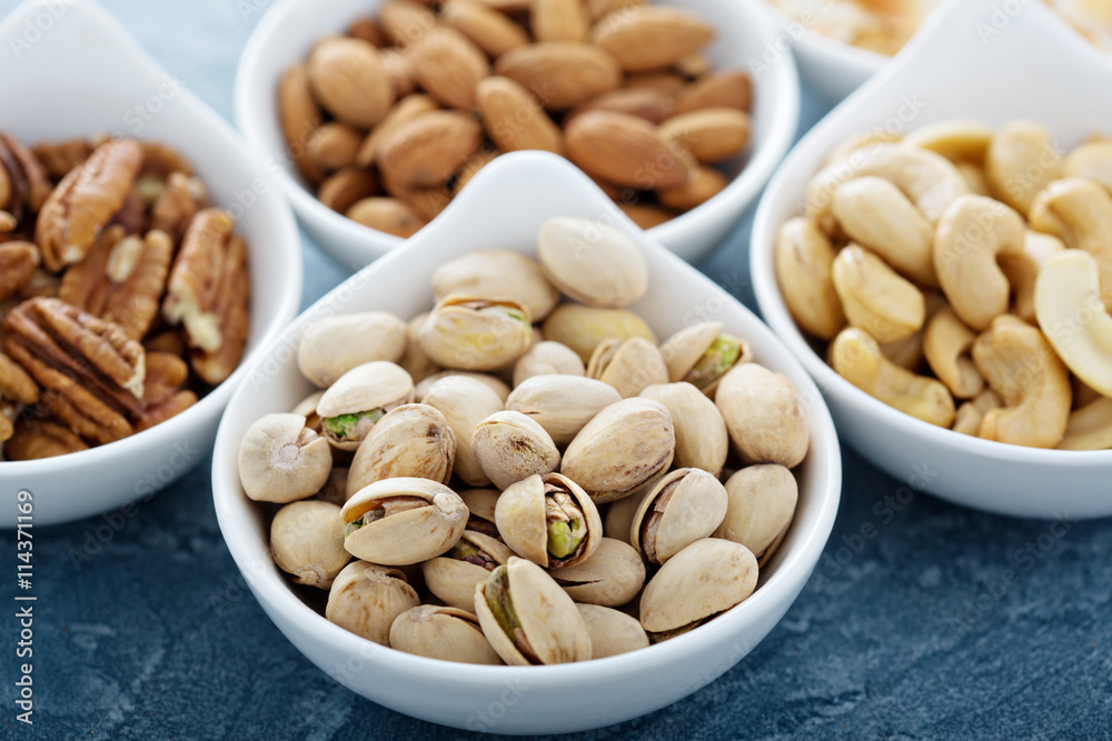 Variety of nuts in small bowls Variety of nuts in small bowls