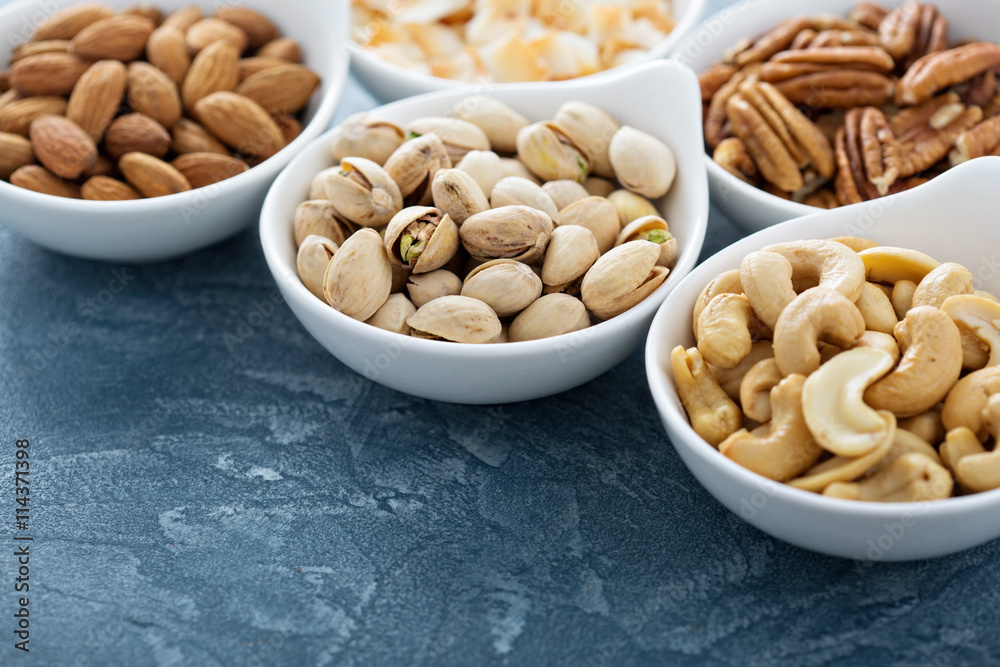 Variety of nuts in small bowls Variety of nuts in small bowls