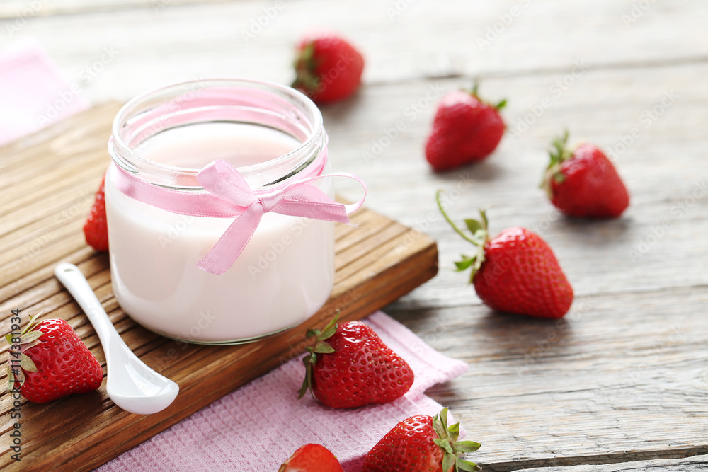 Strawberry yogurt in glass on wooden table Strawberry yogurt in glass on wooden table