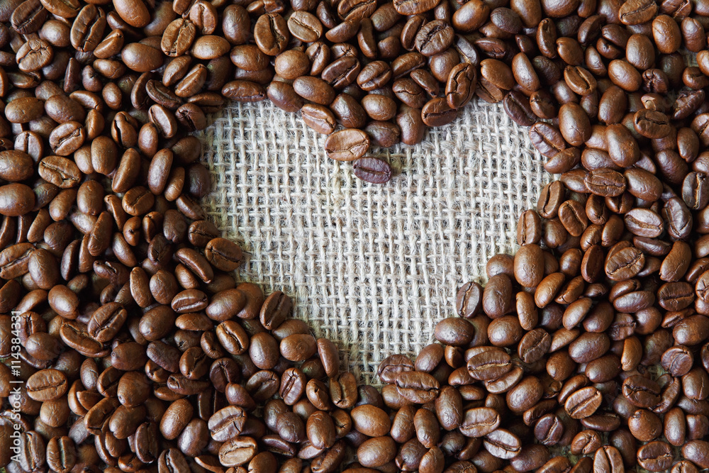 Coffee beans background with burlap heart frame Coffee beans background with burlap heart frame