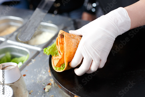 Vendor making crepe with vegetables outdoors