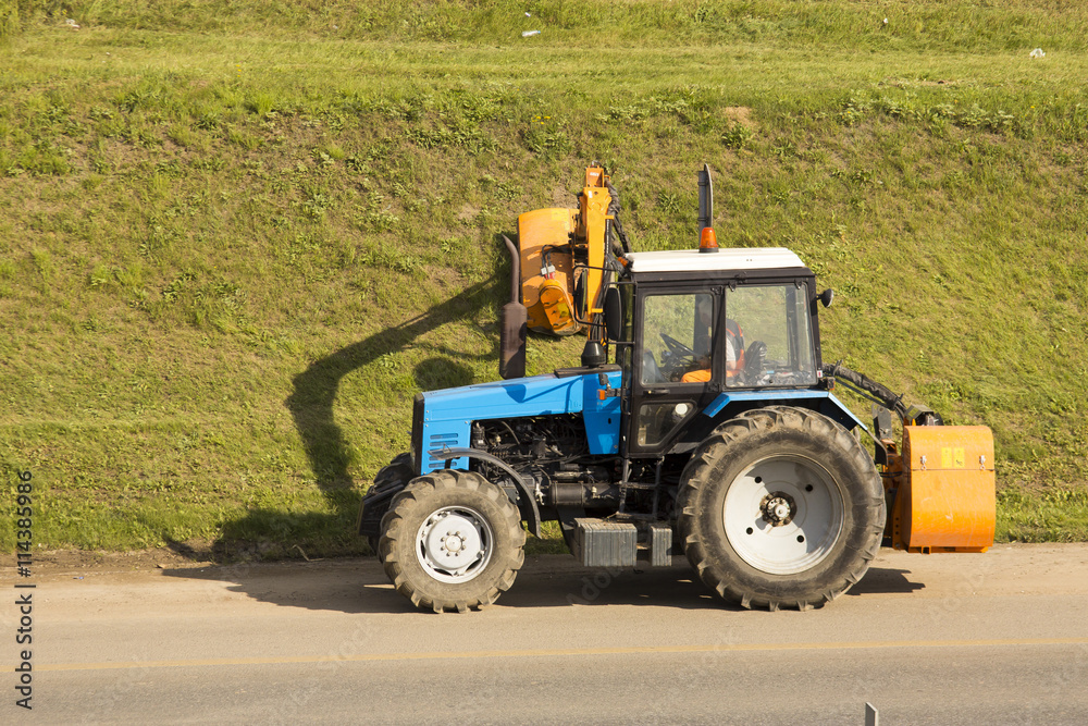 Fototapeta premium tractor mowing the grass