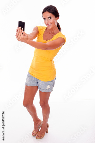 Smiling young brunette with cell phone