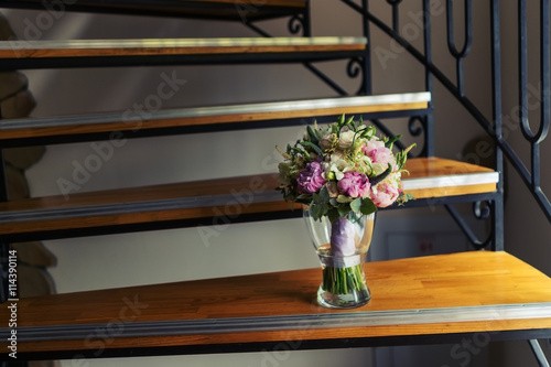 Bride's bouquet in a vase on the stairs