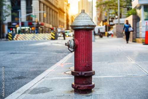 Old red fire hydrant in New York City street. Fire hidrant for emergency fire access photo