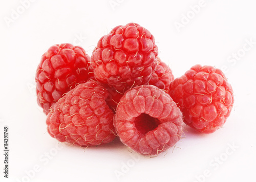 a lot of juicy raspberries on a white background