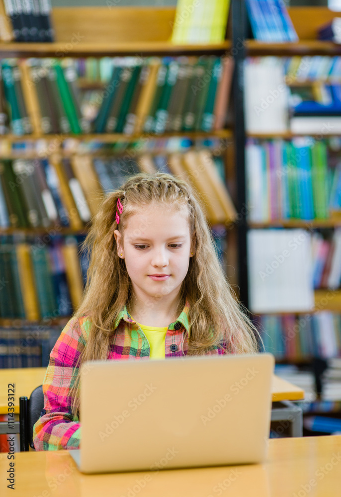 young girl with laptop in library young girl with laptop in library