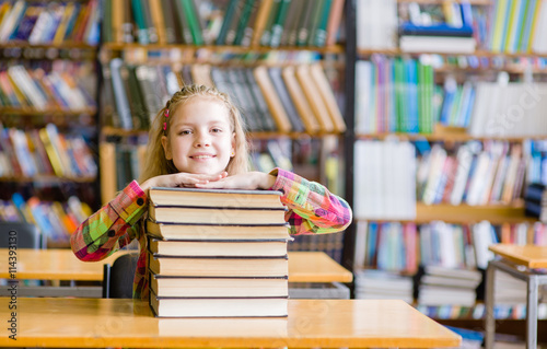 Happy teen girl in library