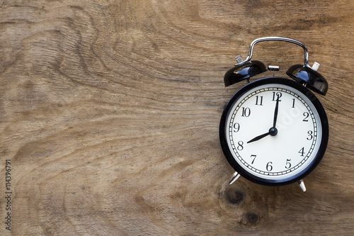 Retro alarm clock on wooden table