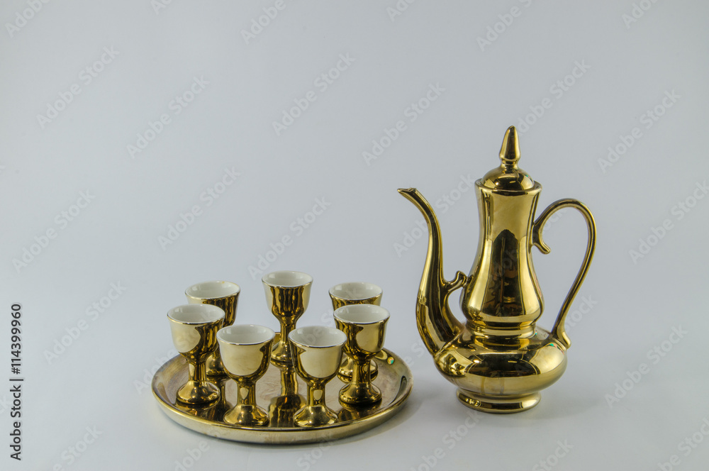 Gold jug Tea glass isolated white background . Gold jug Tea glass isolated white background .