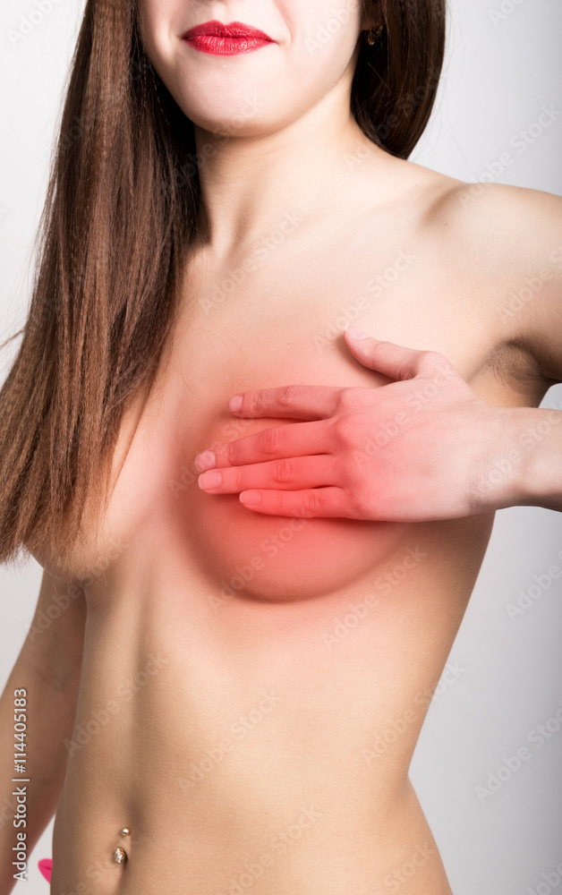 Breast cancer self check. Young woman examining her breast for lumps or signs of breast cancer. healthy lifestyle concept Breast cancer self check. Young woman examining her breast for lumps or signs of breast cancer. healthy lifestyle concept
