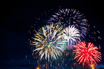 Gorgeous multi-colored fireworks display on dark background