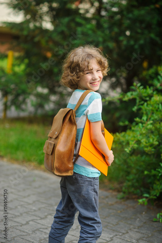 The pupil with a school backpack behind the back.