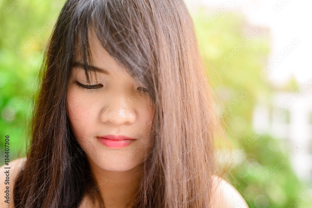 Woman smiling with perfect smile and white teeth in a park and looking at camera Woman smiling with perfect smile and white teeth in a park and looking at camera