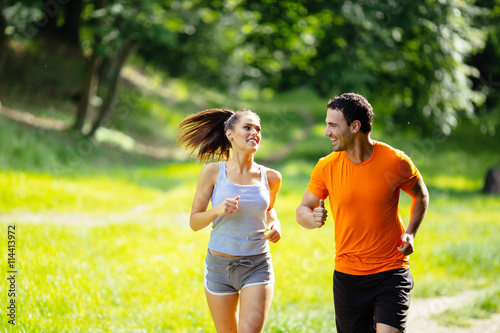 Healthy couple jogging in nature