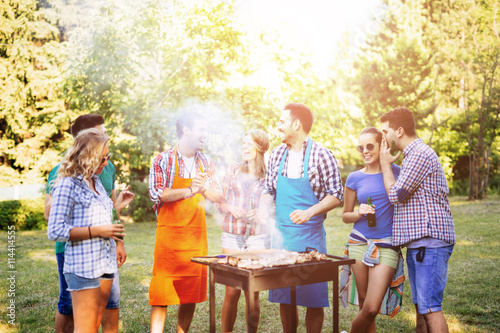 Young people grilling outdoors
