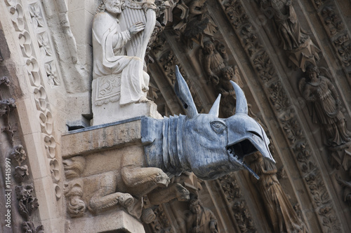 Gargoyle with streched ears on a side wall of the Notre-Dame Cathedral
 photo