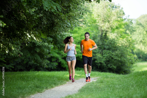 Athletic couple jogging in nature