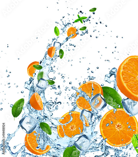 Fresh oranges in water splash over white