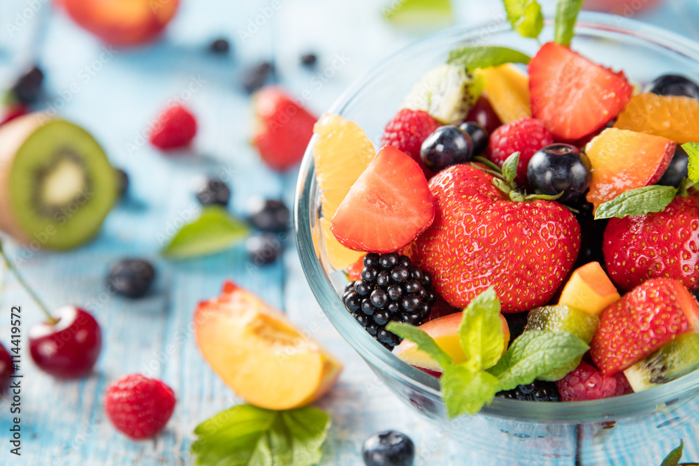 Fresh fruit salad served on wooden table Fresh fruit salad served on wooden table