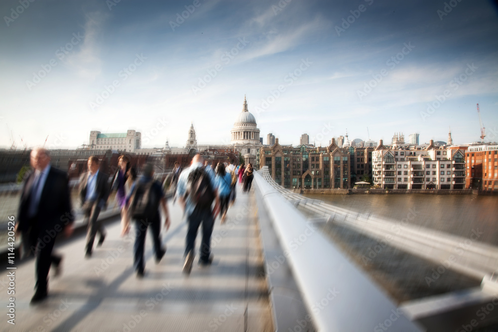 Blurred background of crowd of people on millennium bridge and st pauls cathedral in background, london