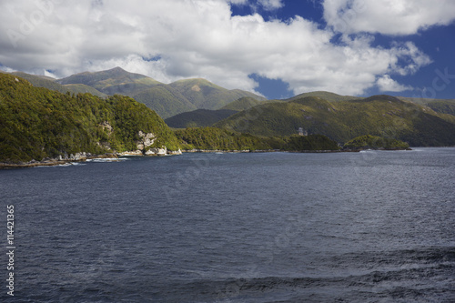 Sun breakes through the clouds at Dusky Sound.