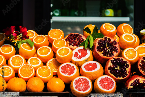 oranges and pomegranates on the market selected focus photo