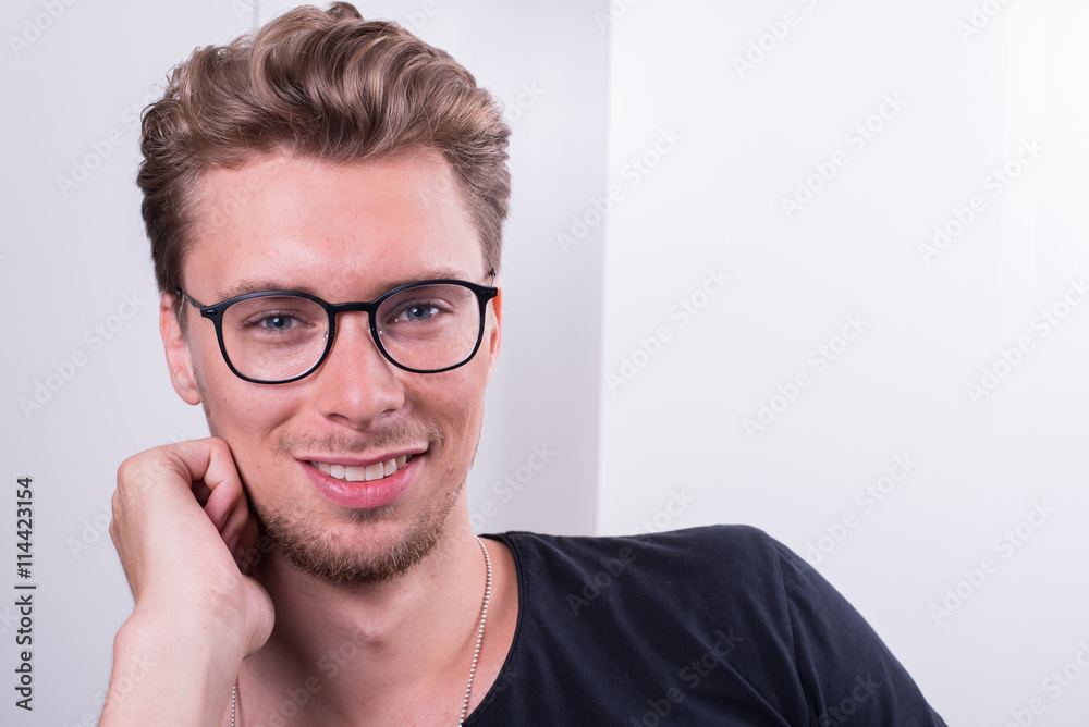 smart young professional smiling into the camera smart young professional smiling into the camera