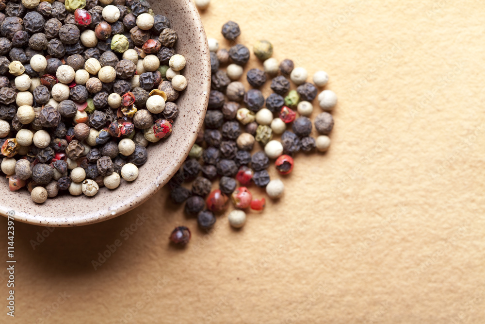 Mix of pepper peas in bowl on paper background Mix of pepper peas in bowl on paper background