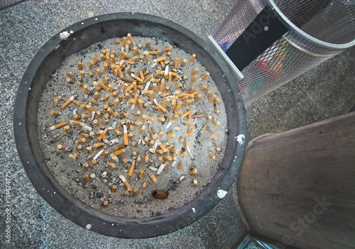 Ashtray full with cigarette stubs photo