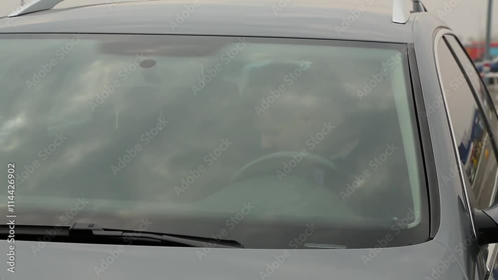 man fastens a seat belt outside view. man fastens a seat belt outside view.